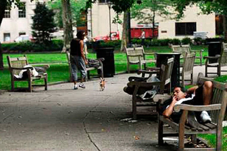 Rittenhouse Square is a summertime magnet for the homeless. On a recent morning, nearly two dozen homeless were asleep on benches. (Sarah J. Glover / Inquirer)
