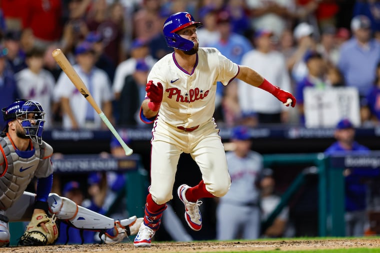 The Phillies' Kody Clemens hits an RBI double in the ninth inning of Game 1 of the NLDS on Saturday. It was his first career postseason hit.