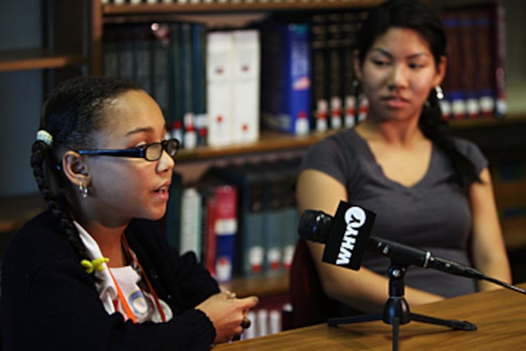 Tamika Miles (left), 11, a sixth grader at Masterman, and Kelly Ca, student-body president, speaking with reporters. Tamika will lead the Pledge of Allegiance for the president's visit. Ca will introduce Obama. (Ron Tarver/Staff)