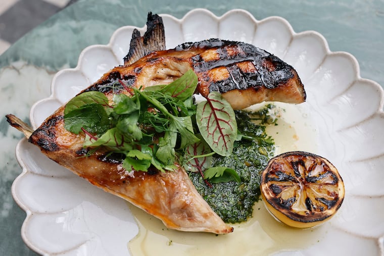 The grilled hamachi collar, Calabrian chili agrodolce, garlic scape salsa verde, and fines herbs at Bastia in Fishtown.