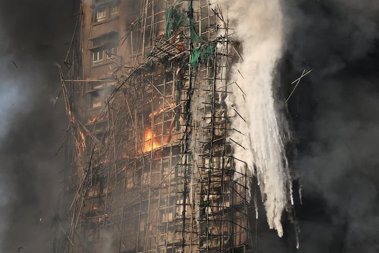 Smoke rises while flames burn bamboo scaffolding on a building at Wang Fuk Court in Hong Kong, China, on Wednesday, Nov. 26.