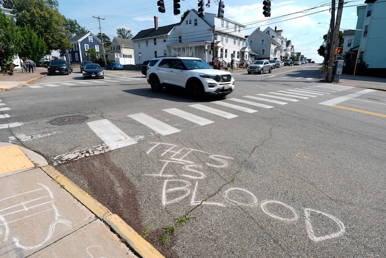 Blood is seen on the pavement near the scene of a fatal shooting by an ICE officer Monday in Biddeford, Maine.