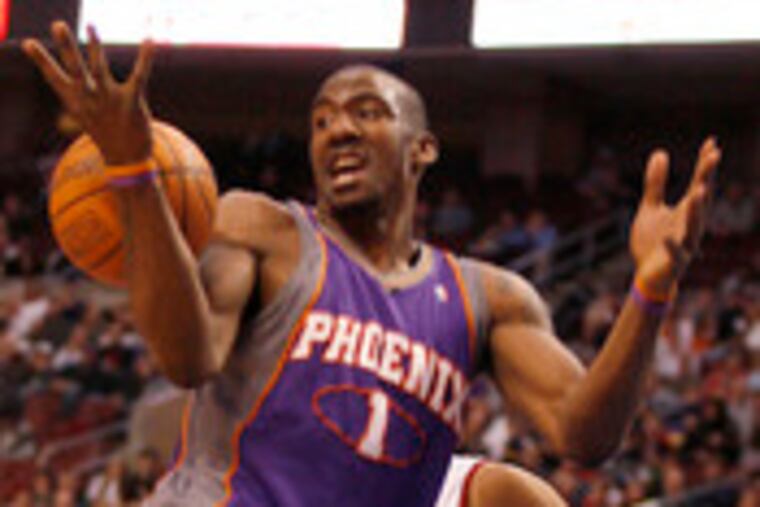 The Suns' Amare Stoudemire loses the ball as he goes up for a layup in the first quarter. The Sixers' Andre Miller is behind him.