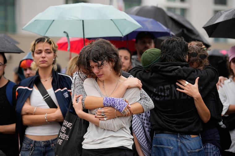 People gather outside the Brandenburg Gate for a demonstration in support of LGBTQ+ after a car rammed into a crowd at the Pride March in Berlin, Sunday, July 26, 2026.