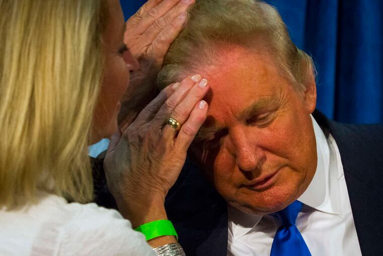Trump asks State Rep. Claire Rouillard to confirm that his hair is real during a rally in Manchester, N.H.