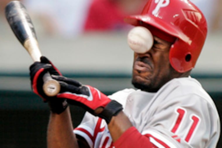 The Phillies' Jimmy Rollins gets smacked in the face by a pitch in the fifth inning of last night's game in Cleveland. Third-base coach Steve Smith is out for the three-game series after his ejection Sunday.