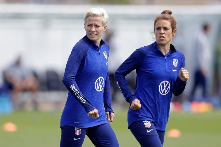 US player Megan Rapinoe, left, runs with Kelley O'Hara, right, during a US womens soccer team training session at the Tottenham Hotspur training centre in London, Thursday, June 6, 2019. The Women's World Cup starts in France on June 7. (AP Photo/Kirsty Wigglesworth)