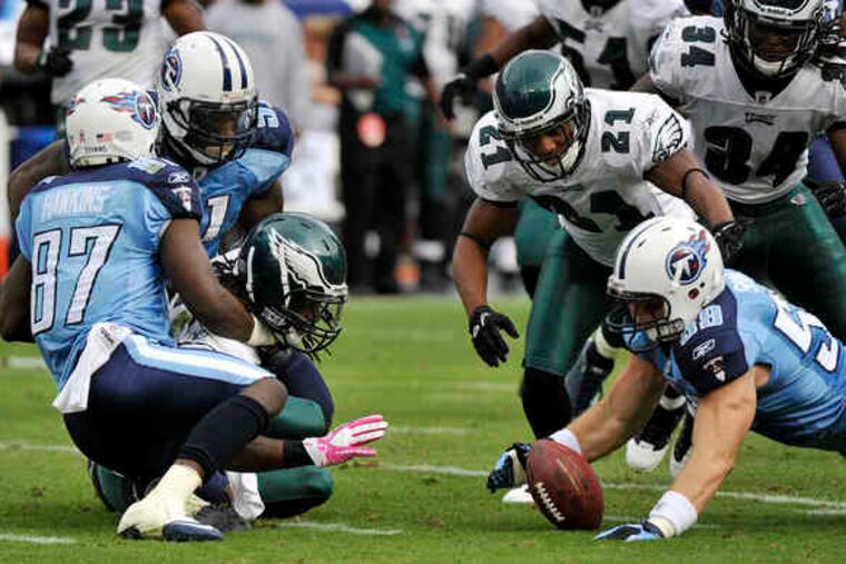 Tennessee's Tim Shaw recovers a fumble by Eagles punt returner Jorrick Calvin.
