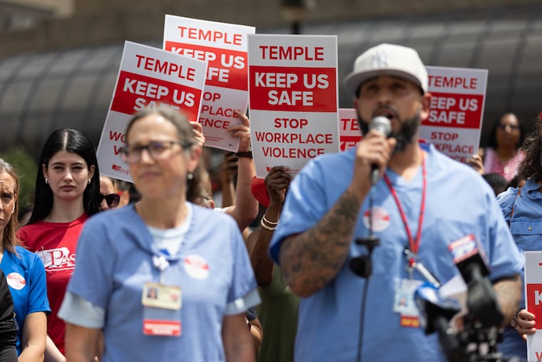 Carlos Aviles (right), a pharmacy technician and president of Temple Allied Professionals, and Marty Harrison (left), a nurse and president of Temple University Hospital Nurses Association, speak during a PASNAP rally outside Temple University Hospital on Wednesday.