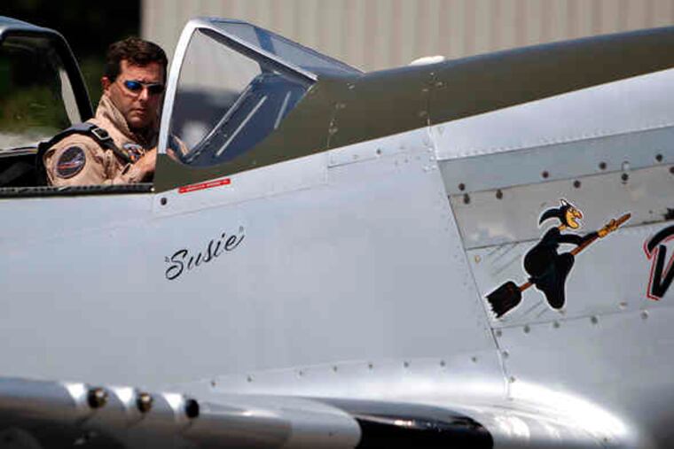Above: Jim Beasley Jr., leader of an aerobatic team of World War II-era fighter planes called the Horsemen, prepares for flight. Below: Ed Shipley, the group's founder, in an AT-6 Texan. The Horsemen will take part in the Atlantic City air show Wednesday.
