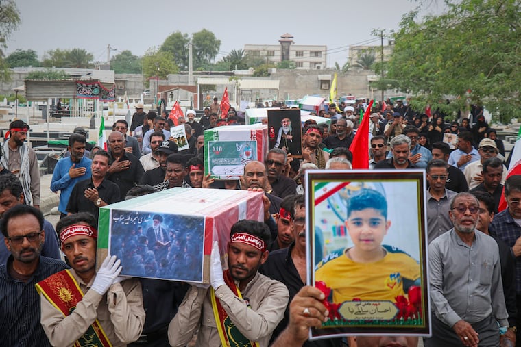 Mourners carry the coffins containing additional remains of victims identified through DNA testing during funeral ceremonies in Minab, Iran, on Tuesday, nearly five months after they were killed in the Feb. 28 strike on the Shajareh Tayyebeh School.