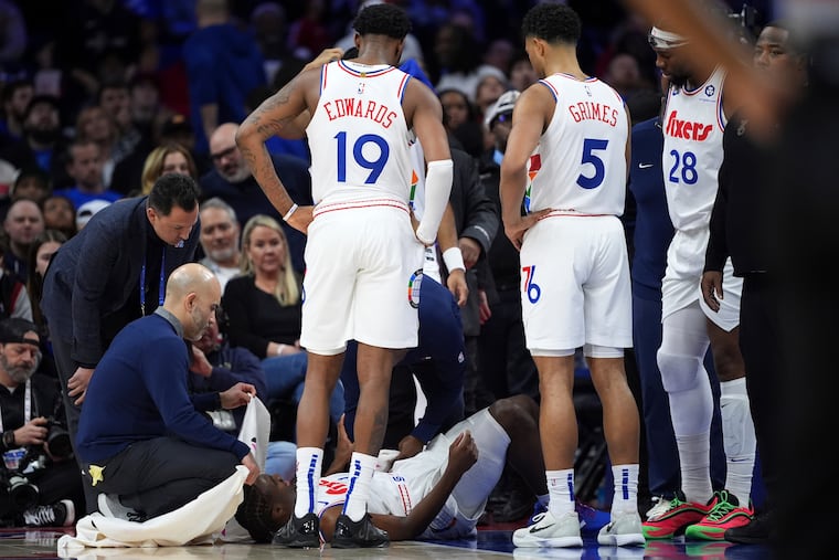 The Sixers' Tyrese Maxey lies on the court after suffering a back contusion during the third quarter. He never returned to the game.