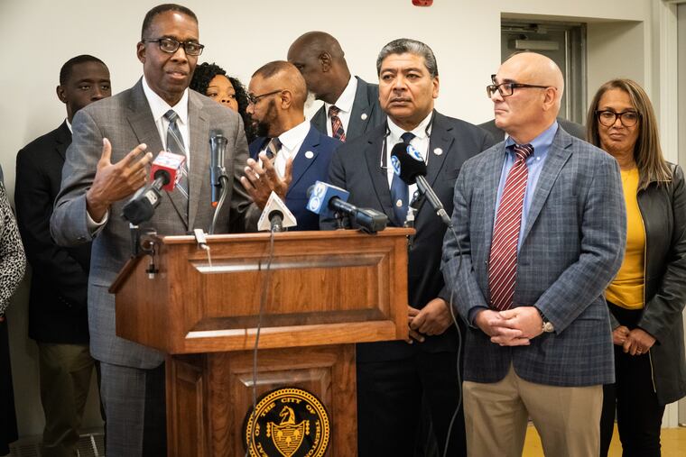 Philadelphia City Council President Darrell Clarke (at the podium) stands alongside Trenton officials during a news conference about the city's gun-violence reduction strategy.
