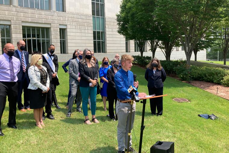 Dylan Brandt speaks at a news conference outside the federal courthouse in Little Rock, Ark., in July 2021. Brandt was among several transgender youth and families who are plaintiffs challenging a state law banning gender confirming care for trans minors.