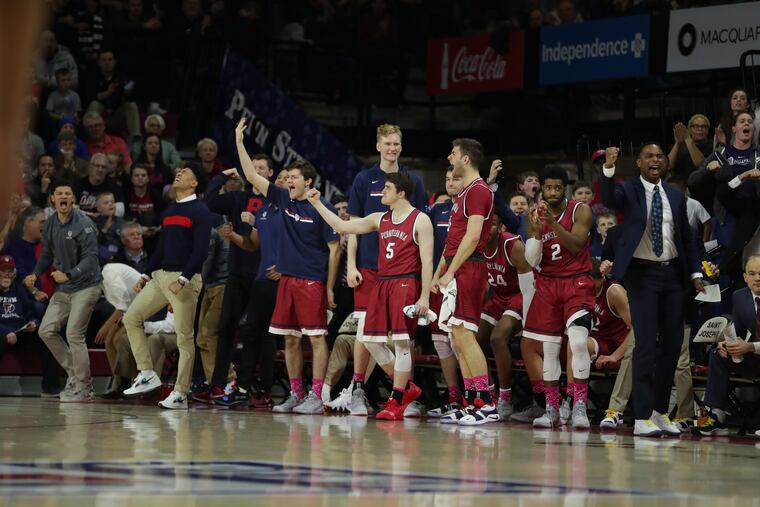 Jelani Williams (at far left, in gray top) has had to keep his Penn basketball game activities to celebrating on the bench.