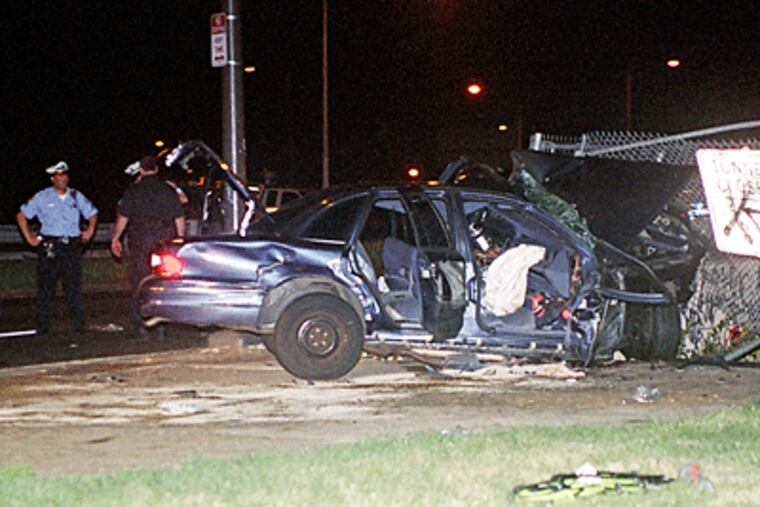 Police examine the wreckage after a two-car chase ended with a crash on the Roosevelt Boulevard near Adams Avenue. One occupant was killed; four others were critically injured, including a 1-year-old. (Alex Lloyd Gross / For the Daily News)