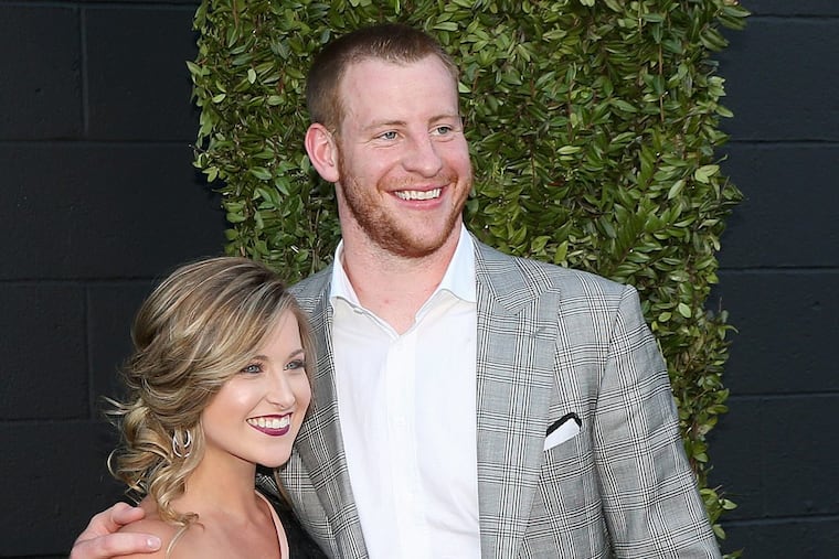 Carson Wentz and his fiancée, Madison Oberg, pose for photos while entering the Eagles' Super Bowl championship ring ceremony at 2300 Arena in South Philadelphia on Thursday, June 14, 2018.