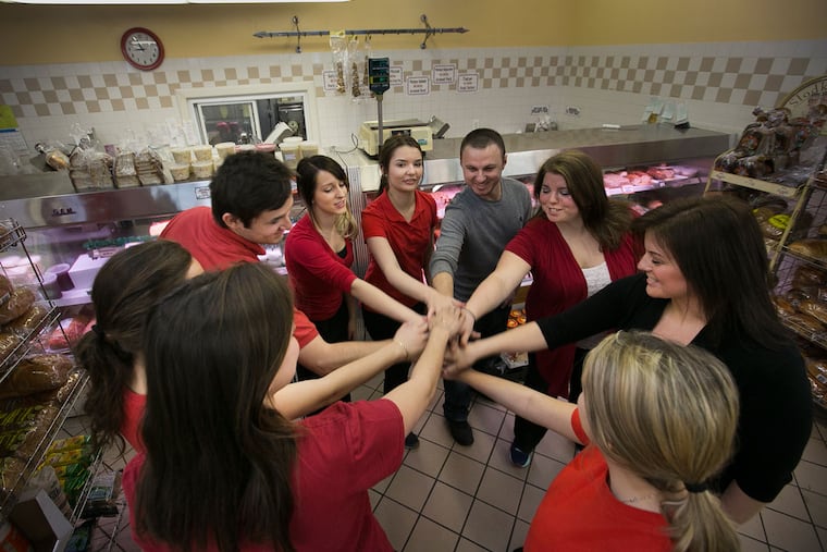Employees of Krakus Polish Market cheer before the start of the busy Good Friday.