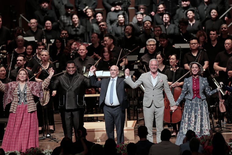 From left: Mezzo-soprano Eve Gigliotti, conductor Anthony Parnther, composer Peter Boyer, librettist Mark Campbell, and soprano Meredith Lustig in front of the Philadelphia Orchestra and the Crossing choir after the premiere of "A Hundred Years On" on Wednesday.