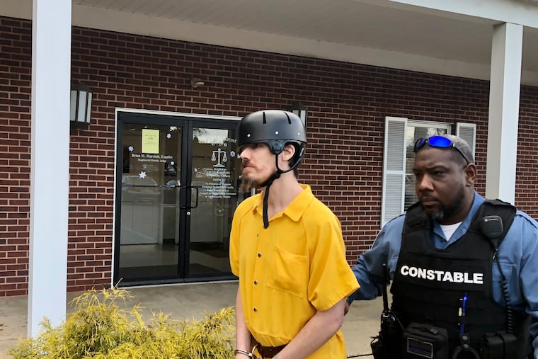 Thadius McGrath, 35, is escorted out of a district court in Northampton Township after his preliminary hearing Thursday.