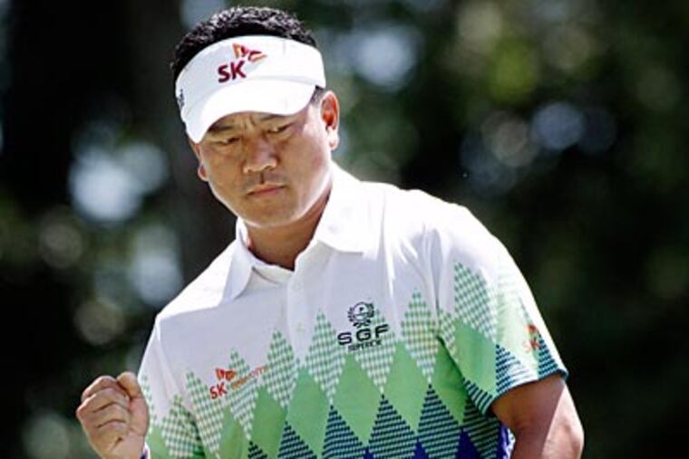 K.J. Choi pumps his fist after sinking a birdie putt on the seventh hole. (Elizabeth Robertson/Staff Photographer)