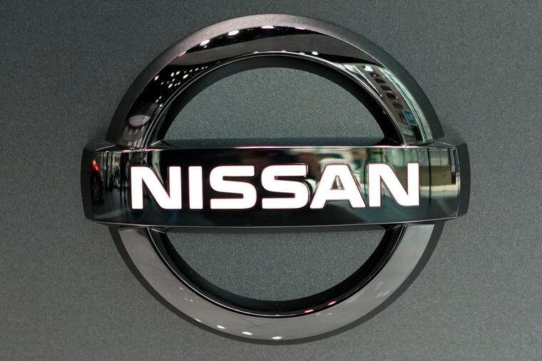 Nissan logo is seen at a Nissan car gallery Thursday, July 25, 2019, in Tokyo. Nissan says it will slash 12,500 jobs, about 9% of its global workforce, to cut costs, achieve turnaround toward growth. (AP Photo/Eugene Hoshiko)