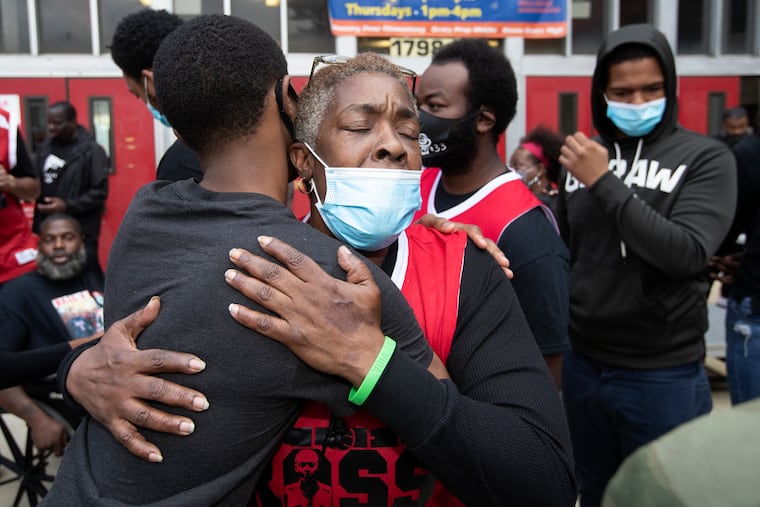 Ross Carter, a 2020 Gratz High School graduate who helped last season’s Bulldogs to the Class 6A city title, was shot and killed in late September while sitting on a friend’s porch in Nicetown. An anti-gun violence rally was held outside of the high school on Oct. 23, 2020 which featured Gratz graduate and NBA great Rasheed Wallace. His grandmother, Michelle Brown, is hugged following the ceremony.
