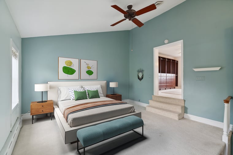 On the third floor is the main suite with a cathedral ceiling and skyline views. The adjoining space could be used as a dressing room, office, or nursery.