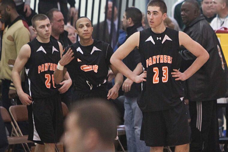 Pitman players (left to right) Kyle Leach, Darnell Foreman and Tyler Wisniewski react to their 64-60 loss to Linden. (David M Warren/Staff Photographer)