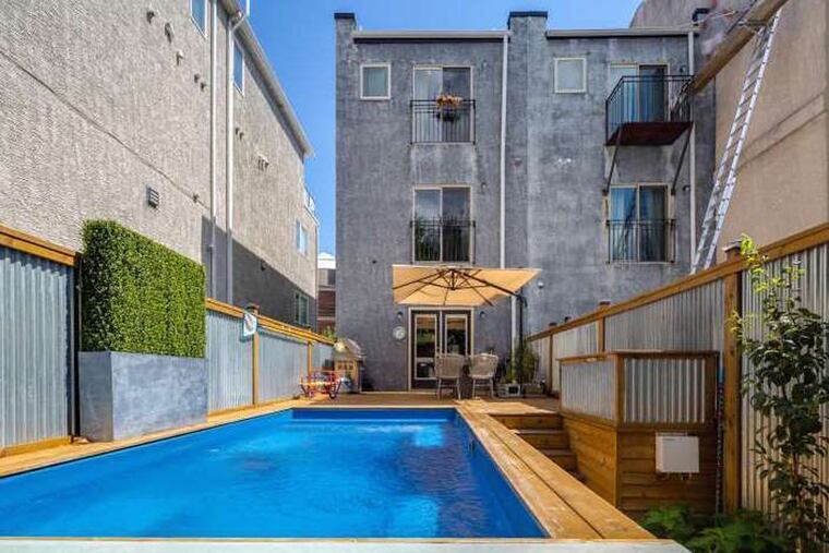 The three-bedroom, 2,475-square-foot-home is set apart by a distinctive feature out back: a semi-in-ground pool and hot tub surrounded by a deck with a swim-up bar.