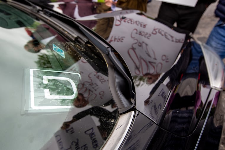 Protesters gather in front of the Uber Green Light Hub near the Philadelphia International Airport during a 2019 rally. Uber drivers and their supporters were fighting for fair wages.