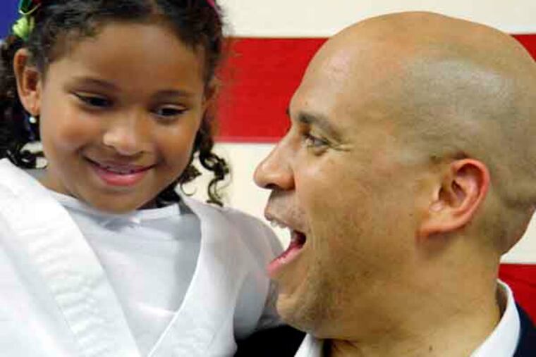 7 yr old Sophia Peragallo of Maple Shade (a self proclaimed Booker fan) was picked up by Cory Booker during a meet and greet at the South Jersey Democrat HQ in Cherry Hill on July 17, 2013. ( ELIZABETH ROBERTSON / Staff Photographer )