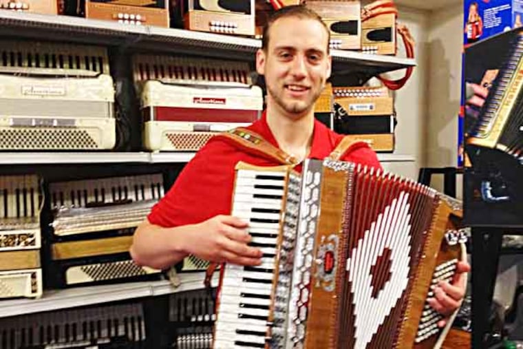 Michael Bulboff, owner of Queen Village accordion shop, with "Baldoni" piano accordion. (Photo: Michael Hinkelman/Daily News Staff)