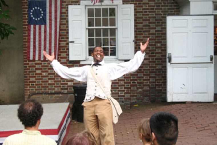 Keith Henley plays the part of Henry "Box" Brown, a Virginia slave who escaped to freedom by arranging to have himself mailed to Philadelphia abolitionists in a dry goods container, at the Betsy Ross House. (Rodrigo Muzell / For the Inquirer)