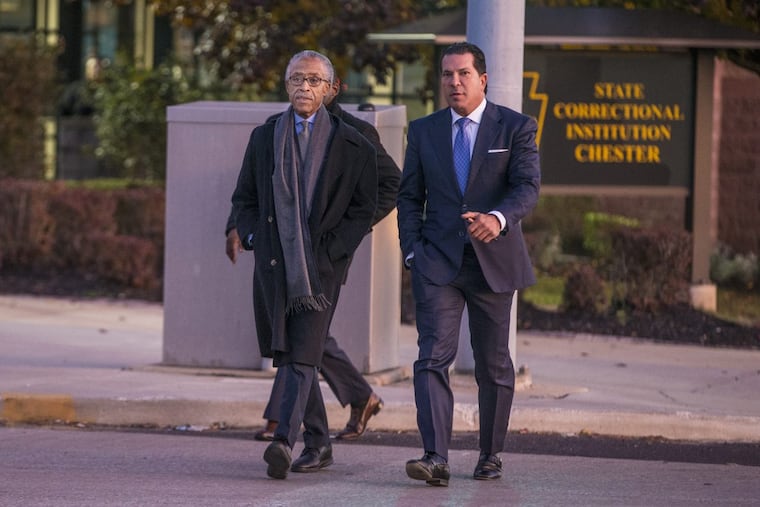 The Rev. Al Sharpton (left) and attorney Joe Tacopina walk out of the State Correctional Institution in Chester after talking to rapper Meek Mill on Monday.