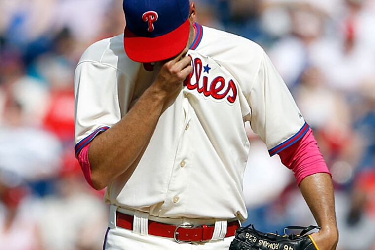 Jeanmar Gomez wipes his face after giving up two runs. (Yong Kim/Staff Photographer)