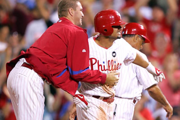 Shane Victorino got mobbed by his teammates after driving in the game-winning run in the bottom of the ninth inning. (David Swanson / Staff Photographer)