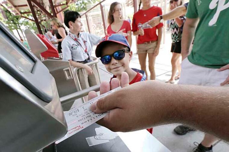 Gavin Carnivale, 7, of Maple Shade, waits for his ticket to be scanned before entering Citizens Bank Park. ( ELIZABETH ROBERTSON / Staff Photographer )