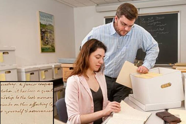 Graduate students Amanda Daddona and Matthew Davis sift through documents at the University of Delaware Library, where an 1808 letter written and signed by Thomas Jefferson was discovered. (Kathy Atkinson, University of Delaware)