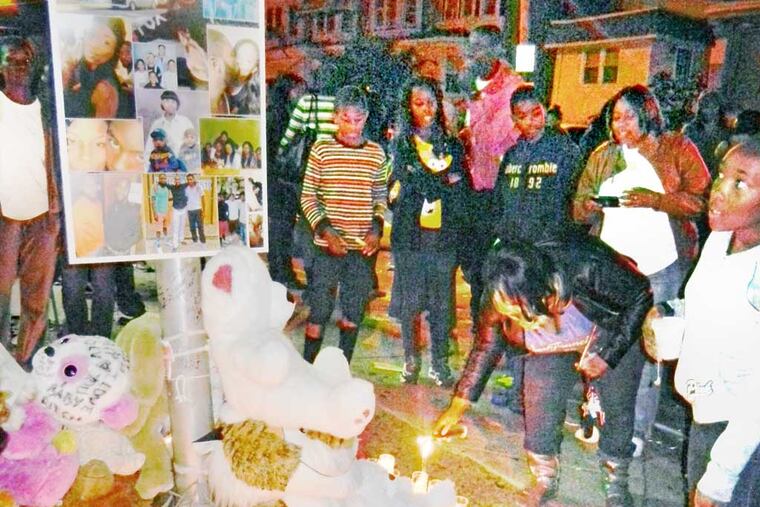 Mourners gather to remember Devin Hatch, 22, October 8, 2013, in Philadelphia, at a candlelight vigil. Hatch was killed Sunday in a wild shootout in Kingsessing that injured six others. (Solomon Leach / Daily News Staff)