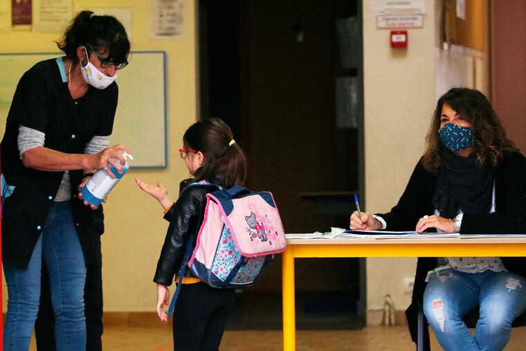 A school child used a disinfectant solution as she arrived at her school in Saint Jean de Luz, southwestern France in May.