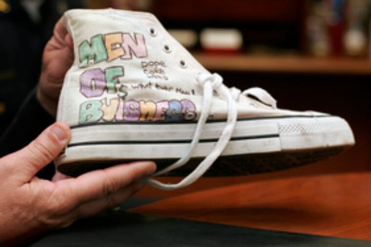 The words on this sneaker taken from an inmate at the Camden jail start with "MOB" - meaning "Member of Bloods."