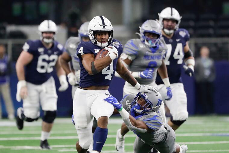 Penn State running back Journey Brown runs past Memphis defensive back Quindell Johnson.