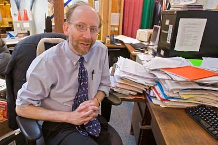 Paul Socolar, editor and director of the Philadelphia Public School Notebook, sits at his desk in the paper's newsroom. (David M. Warren / Staff Photographer)