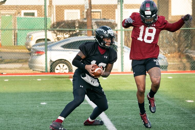 Todd Centeio (left) with receiver Jaden Blue during a spring practice last month.