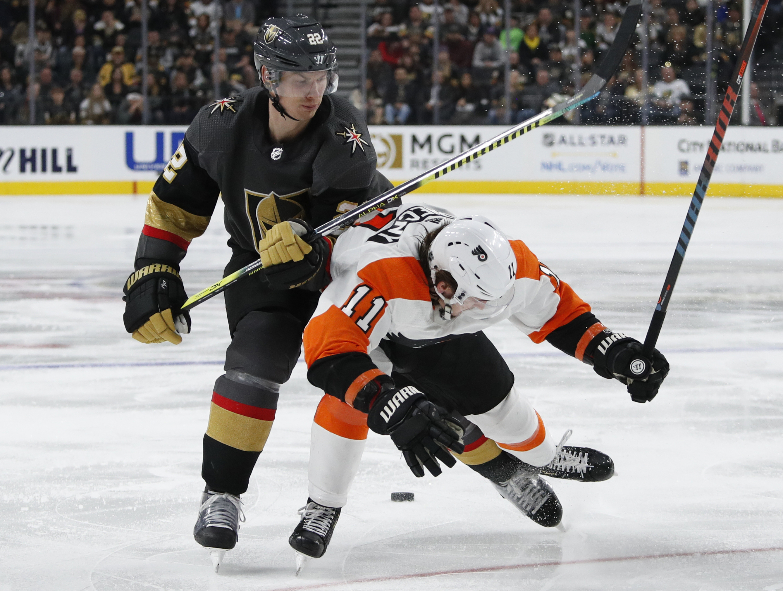 Golden Knights defenseman Nick Holden (22) checks Philadelphia Flyers right wing Travis Konecny (11) during the third period Thursday.