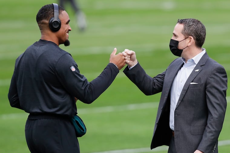 Quarterback Jalen Hurts meeting with general manager Howie Roseman before the Eagles played the New Orleans Saints on Dec. 13, 2020.