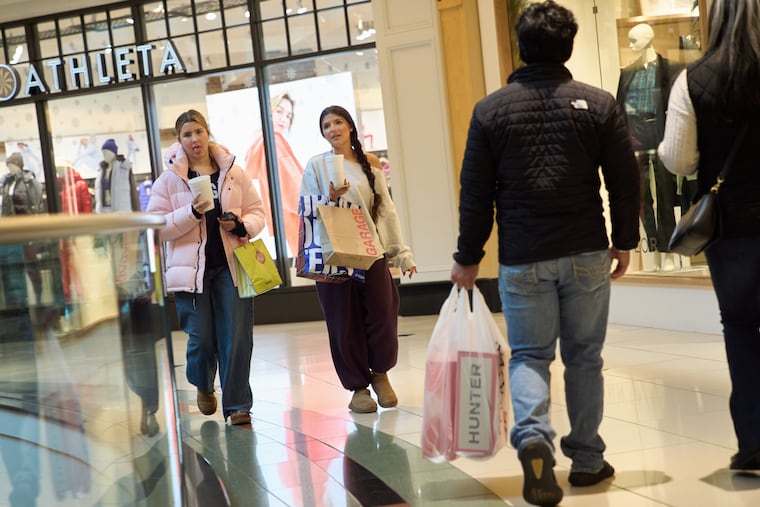 Shoppers walk around a mall in Troy, Mich., on Wednesday, Dec. 10.