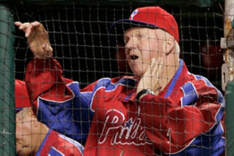 Above, manager Charlie Manuel registers amazement and dismay as the Phils sag to a 7-0 deficit. Below, pitcher Jamie Moyer throws to first for an out after fielding a hit by Toronto pitcher Shaun Marcum.