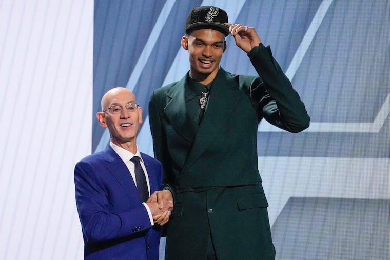 Victor Wembanyama poses for a photo with NBA commissioner Adam Silver after being selected first overall by the San Antonio Spurs during the NBA basketball draft, Thursday, June 22, 2023, in New York.